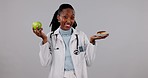 Face, black woman and doctor with apple, donut and options with decision on a white studio background. Portrait, happy African person and medical professional with healthcare, nutrition and diet plan