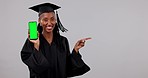 Black woman, graduation and phone green screen in advertising against a studio background. Portrait of happy African female person, student or graduate smile showing smartphone app, display or mockup