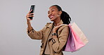 Woman, selfie and shopping bag for social media marketing, commerce and influencer blog in studio. Happy african person or customer in profile picture and beauty package for sale on white background