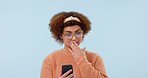 Wow, news and woman with phone in studio for social media, text or chat on blue background. Smartphone, surprise and lady model shocked by sign up giveaway, gossip and drama or secret notification