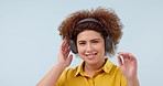 Music headphones, dancing and happy woman streaming media, listening and hearing audio online. Smile, radio and person moving to sound for freedom isolated on a blue background mockup space in studio