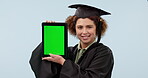 Tablet, green screen and a woman student at graduation in studio on a gray background for education. Portrait, smile and a university graduation showing chromakey mockup space on a technology display