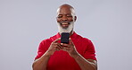 Phone, smile and social media with a senior black man in studio on a gray background for communication. Contact, funny and an elderly person laughing at a comic, meme or internet post on his mobile