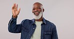 Mature, man and waving at you with face in studio on background for mockup with greeting, welcome and smile in happiness. African, person or model with confidence, laughing and excitement for offer