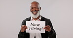 Senior, hiring sign and black man in business, opportunity or interview against a studio background. Portrait of mature African male person, CEO or executive showing billboard or poster in recruiting