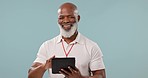 Happy, black man or coach with a tablet on a blue background for a fitness app or communication. Smile, mature and an African personal trainer typing on technology for sports update or progress