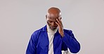 Tired, dirty and black man on a studio background for maintenance, construction or building. Fatigue, burnout and a mature African handyman with a headache or stress after technician work or service