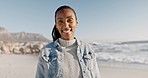 Smile, portrait and black woman on beach for holiday on calm tropical island in summer waves with blue sky. Relax, nature and face of happy girl on ocean vacation with peace, sea water and travel.