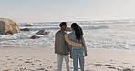 Black couple, walking and beach with back, love and care together by the sea by water. Happy, freedom and vacation with young people relax with embrace by the ocean on adventure with travel