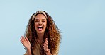 Face, dance and excited woman in celebration, clapping and winner in studio isolated on a blue background mockup space. Portrait, happy person moving with energy and applause for success of good news