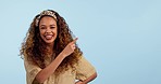 Excited, pointing and face of woman in a studio with mockup space for marketing or advertising. Happy, smile and portrait of female model from Colombia with a showing hand gesture by white background