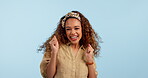 Face, dance and excited woman in celebration in studio isolated on a blue background mockup space. Portrait, happy person moving with energy and smile at music party for success, winner and good news