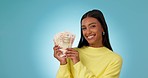 Money winner, face or happy woman with lottery jackpot for winning competition giveaway or cash prize. Financial, euros or excited rich person with wealth or gambling on blue background in studio