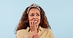 Face, biting nails and woman in studio with anxiety for news, feedback or review on blue background. Stress, thinking and  lady model with mental health crisis, trauma or disaster emoji oops mistake