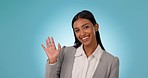 Business woman, wave and hello portrait in studio for presentation, video call and talking to audience. Face of a indian person, presenter or speaker with a hand gesture, greeting and blue background