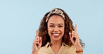 Happy, pointing up and face of woman dance in studio for deal, announcement or notification on blue background. Smile, portrait and excited lady model with emoji hand show news, sale or service offer