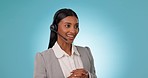 Call center, talking and woman in studio for customer service, FAQ advisory or IT questions. Indian telemarketing agent, virtual consultant or telecom communication with microphone on blue background