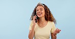 Smile, phone call and woman in a studio laughing for comic, comedy or funny joke in conversation. Happy, communication and young female model on mobile discussion with cellphone by white background.