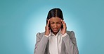 Business woman, headache and pain in studio for burnout, stress and bankruptcy risk on blue background. Tired indian worker massage temple for anxiety, brain fog and crisis of challenge, debt or fail