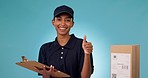 Happy woman, delivery and writing with thumbs up in logistics, shipping or inspection against a studio background. Portrait of female person with box, checklist or like emoji for courier service