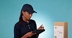 Delivery, check package and tablet with woman in studio, inventory and information on box on blue background. Distribution, supplier and online system, barcode inspection and shipping with e commerce