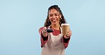 Woman with card machine, payment and coffee with technology, finance and smile in studio on blue background. POS, banking and mockup space, barista in portrait with drink, small business and owner