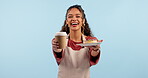 Coffee, donut and happy waitress, woman or cafeteria server giving restaurant food, morning drink or dessert. Studio portrait, cafe diner and barista with tea cup, sweets and smile on blue background