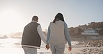 Holding hands, couple and walking on sunset beach together for fun vacation, holiday or travel. Back of a woman and man stroll by ocean with love, romance and adventure outdoor with space by water