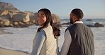 Walking, beach and couple holding hands by ocean for commitment, bonding and relax in nature. Happy marriage, travel and portrait of man and woman for romance on holiday, vacation and anniversary