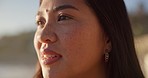 Thinking, happy and face of woman at beach for relaxing on holiday, vacation and weekend outdoors. Travel, nature and person looking at view, sunset and ocean for calm, reflection and peace by sea