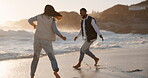 Couple, running and sunset splash at a beach for fun vacation, holiday or travel. Woman and man at ocean with love, romance and adventure or energy outdoor to relax and play on honeymoon by water