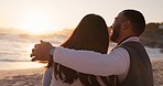 Happy couple, sunset and beach with love, hug and travel by the ocean by water sitting on sand. Vacation, island and date by the sea of young people back together with summer peace and relax outdoor