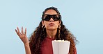 Woman, 3d movie and glasses for popcorn, studio or confused with questions by blue background. Girl, eating snack and holographic vision for anxiety, suspense or film in cinema, theater or television