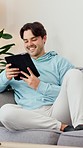 Happy, man and relax with tablet on sofa to watch movies, search meme and download multimedia games at home. Digital technology, ebook and smile to update social media post, blog and online shopping 