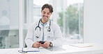 Doctor, man and phone in office for communication, typing and chat with network connection and smile. Professional, healthcare and person with smartphone for conversation, email and technology at job