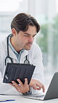 Tablet, doctor and laptop in office for research, telehealth and information with network connection and focus. Professional, healthcare and person with digital pc for health planning and analysis
