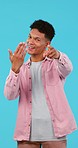 Face, man and hand pointing at you with come in studio with offer, presentation or welcome on blue background. Happy, portrait and male student with choice, invitation or decision with join us sign