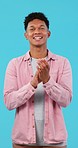 Applause, support and winner, man and face with happiness, praise and pride isolated on blue background. Smile in portrait, celebration and audience with clapping, success and achievement in studio