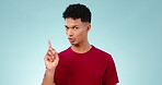 No, unhappy and face of a man with disapproval on a studio background for depression or mental health. Anxiety, stop and portrait of a man with a finger or gesture for wrong, frustrated or stress