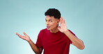 Talking, face and a man listening on a blue background for communication, privacy or a secret. Speaking, gossip and portrait of a person with a whisper, hearing and conversation with attention