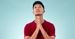 Hands, talking or man in studio praying for hope of help or guidance to worship God on blue background. Stress, anxiety or sad Christian person asking in prayer to Jesus Christ for spiritual support