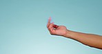 Calling gesture, hand and blue background for communication, talking or conversation. Studio, arm and fingers of a person for speaking, discussion or expression on a mockup backdrop for showing