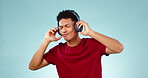 Happy man, headphones and dancing studio with music, radio or audio with energy on blue background. Listen, dancer and person with digital media streaming hip hop, sound or podcast for freedom