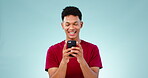 Phone, man and comic face in studio for social media, funny meme or streaming movie show on blue background. Smartphone, person and laughing at internet gif, website search or online post with mockup