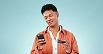 Phone, credit card and man in studio for online shopping with a deal, sale or promotion. Technology, retail and male model from Mexico with cellphone for internet payment of bills by blue background.