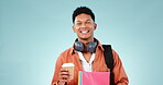 Coffee, books and headphones with a student man in studio on a blue background for education or learning. Portrait, smile and study with a happy young university or college pupil looking confident