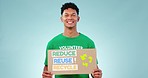 Volunteer man, recycling poster and studio with smile, face or promo for earth day by blue background. Ecology activist, voice and protest for global warming, climate change and billboard for future