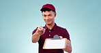 Documents, signature and a delivery man with a contract on a blue background in studio for shipping. Portrait, pen and clipboard with a young courier for post office logistics or supply chain