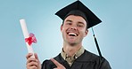 Graduation, man and certificate in studio, smile and face for achievement, goal and pointing by blue background. College student guy, diploma and emoji in portrait for education, review and success