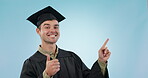 Happy man, studio student and graduate pointing at education announcement, school notification or mockup space. Study portrait, graduation thumbs up and university learner ok sign on blue background 